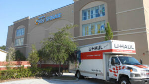 Uhaul truck parked in front of a Compass Self Storage facility.