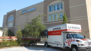 Uhaul truck parked in front of a Compass Self Storage facility.
