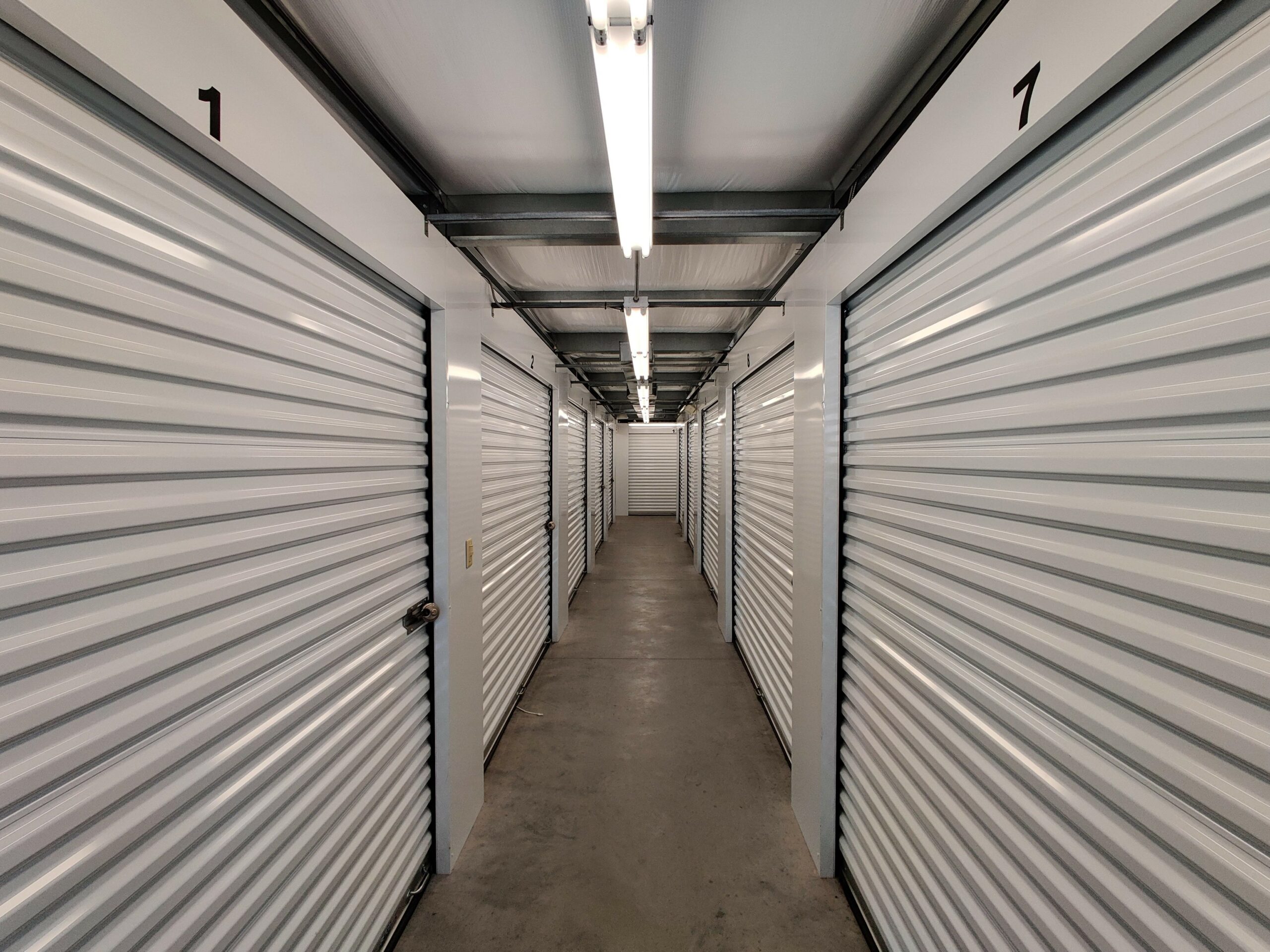 Hallway inside storage facility with indoor storage units.