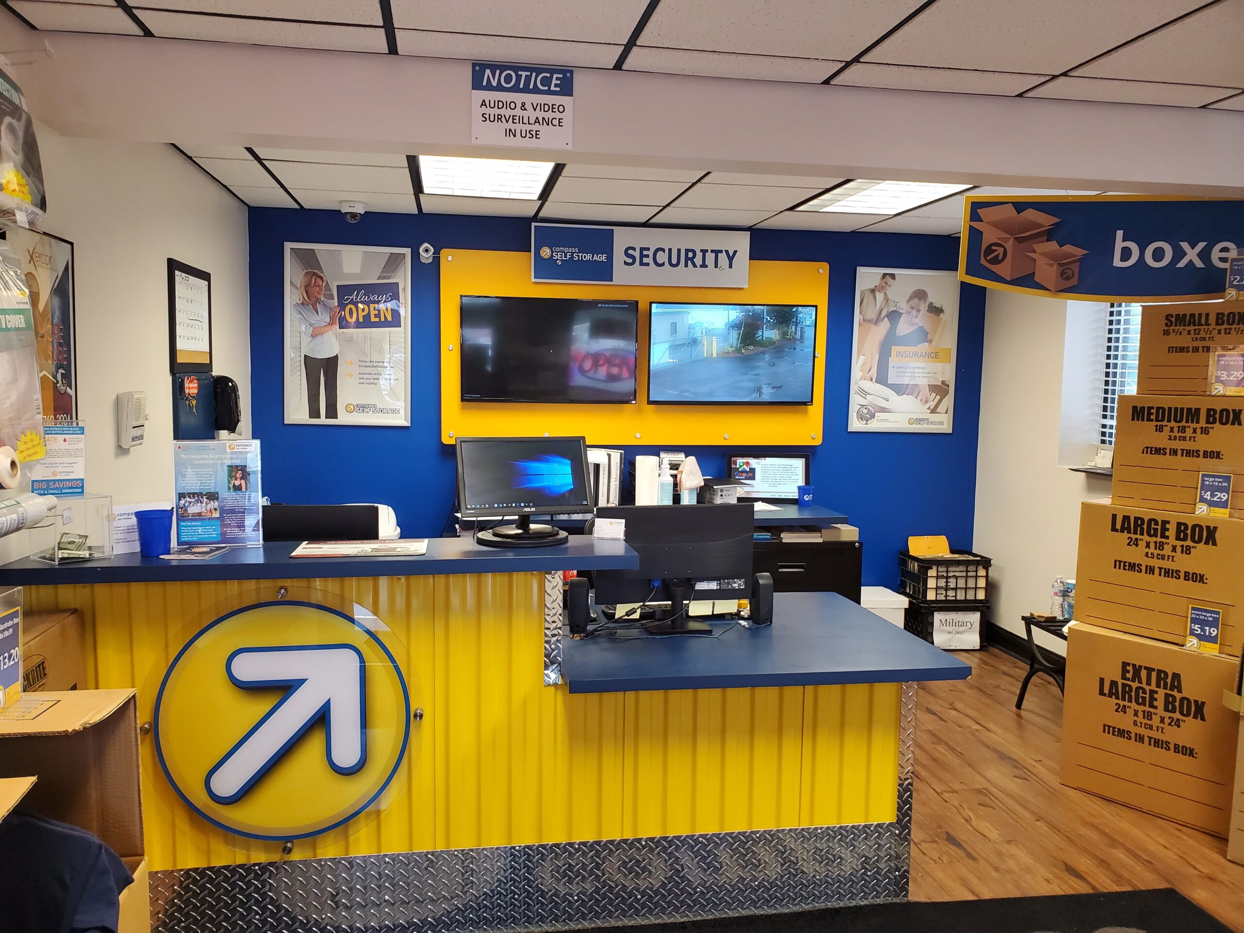 Small yellow and blue office with boxes for sale.