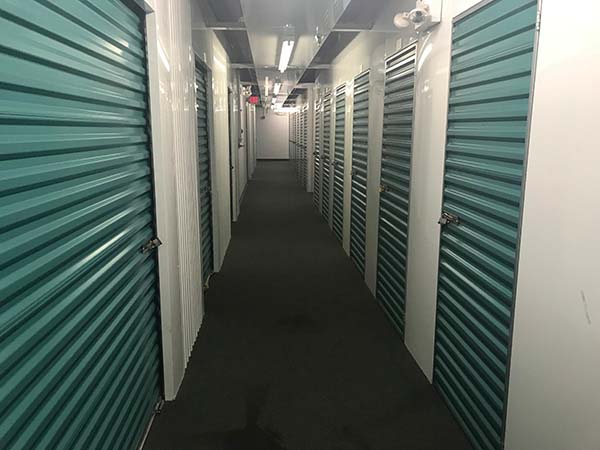 Indoor self-storage with teal doors.