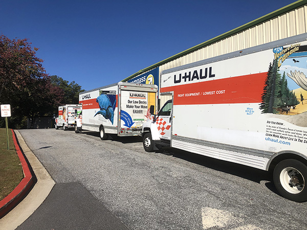 U-Haul trucks parked around storage facility.