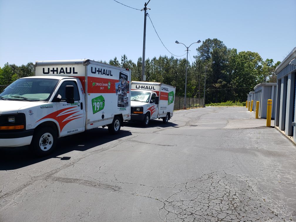 U-Haul trucks parked near storage units.
