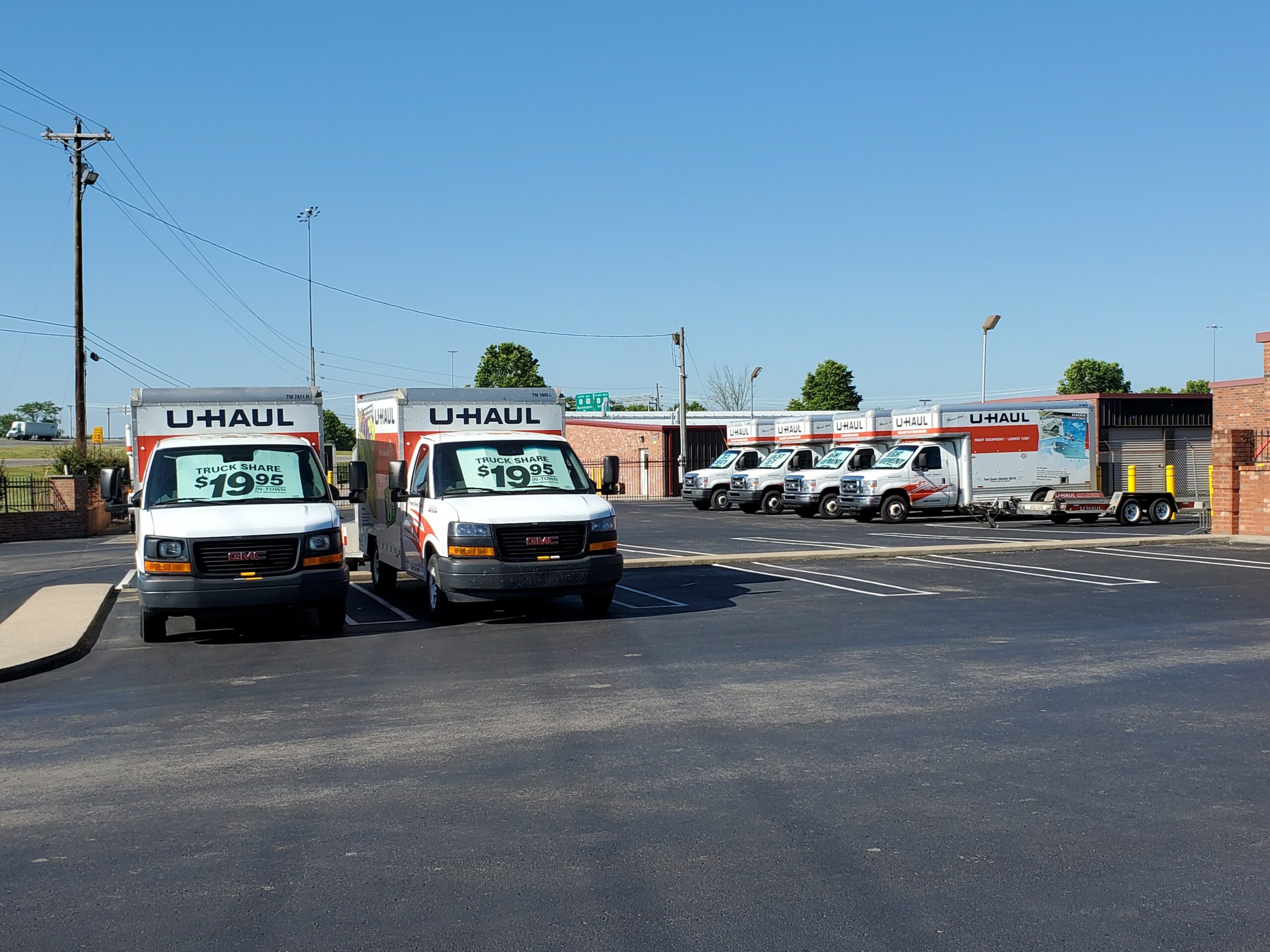 U-Haul moving trucks parking in parking lot available for rent.