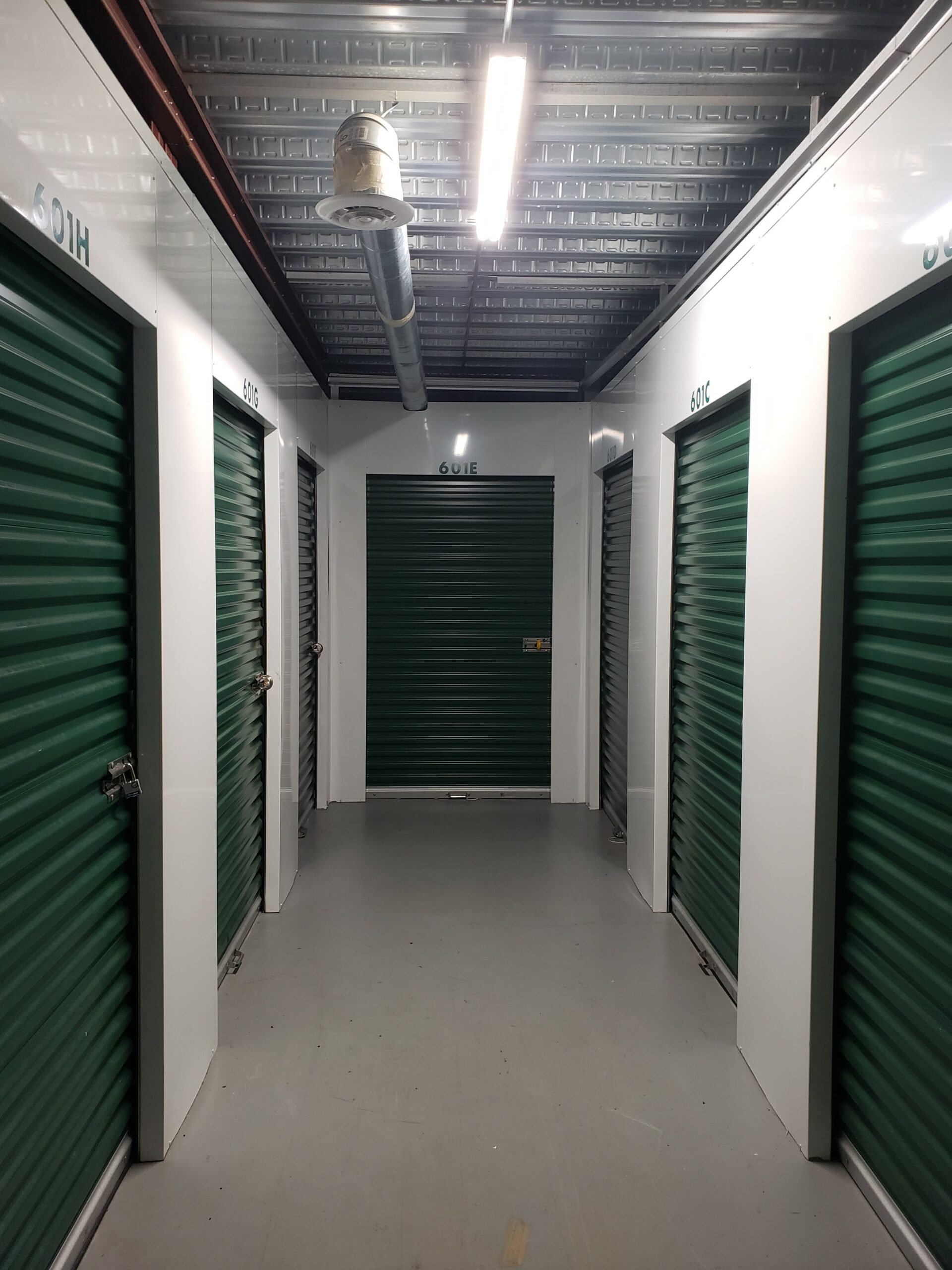 Indoor storage units with green doors.