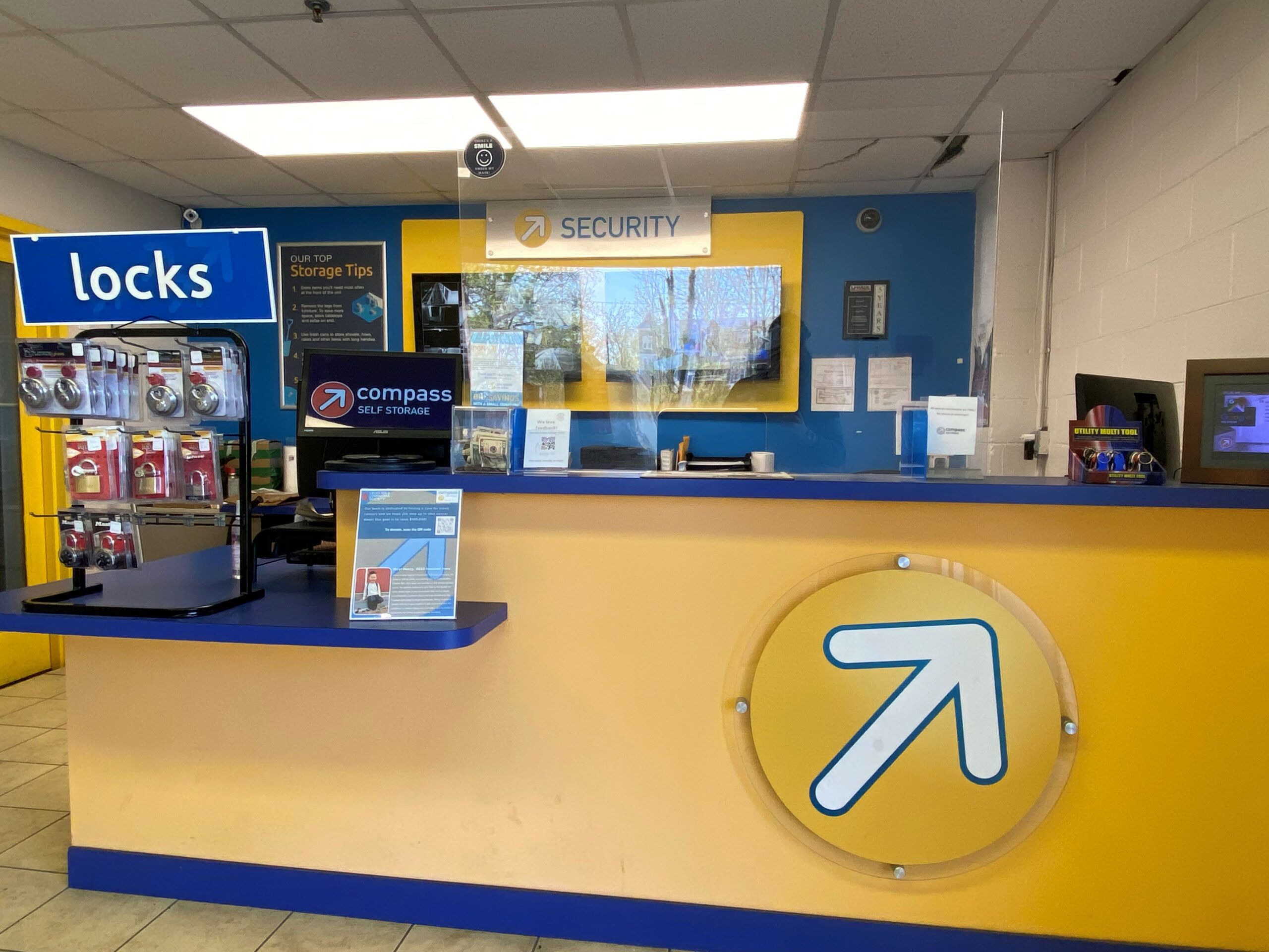 Yellow and blue office with Compass logo on desk.