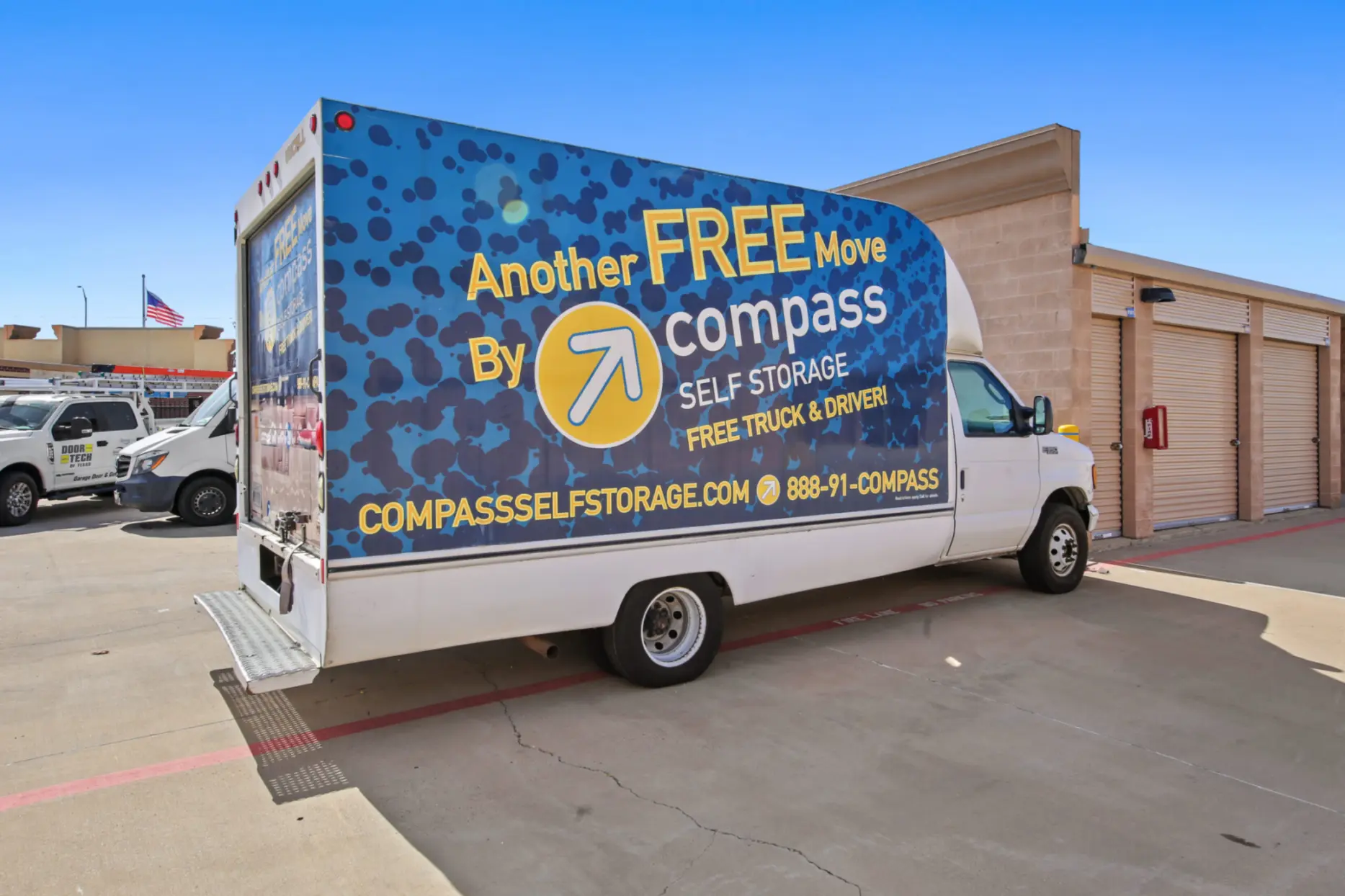 Compass Self Storage free truck rental parked in parking lot at facility.