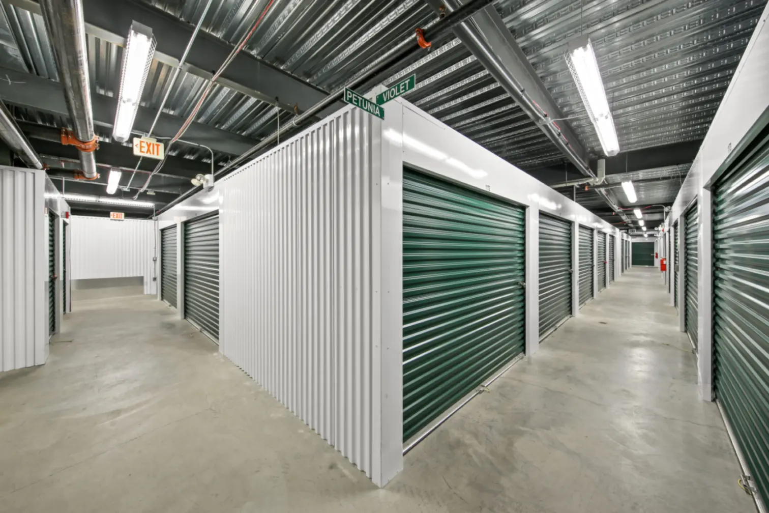 Compass Self Storage indoor storage units with green doors.