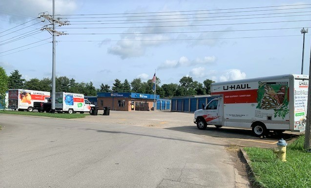 U-Haul rental trucks parked in front of Compass Self Storage facility.