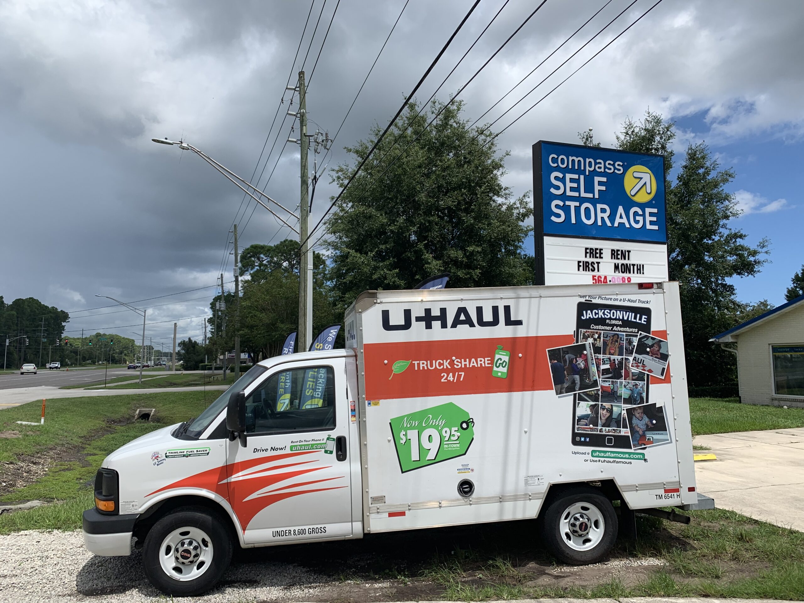 U-Haul truck parked in front of sign.