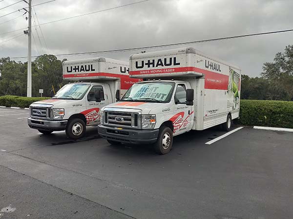 U-Haul moving trucks parking in parking lot available for rent.