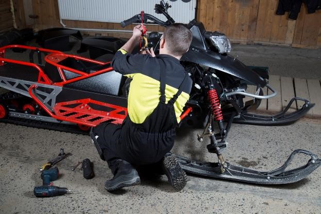 A snowmobile in a garage