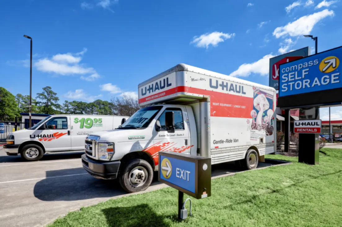 U-Haul rental trucks parked in parking lot.