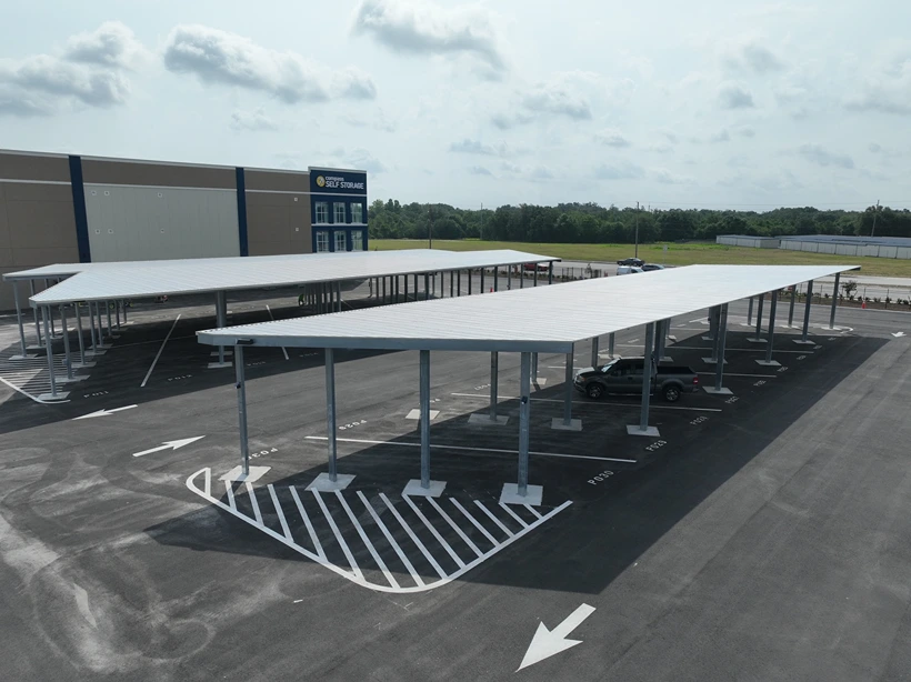 Outdoor vehicle parking with overhead roof cover.