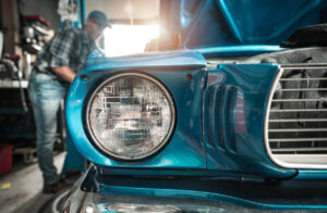 Classic Cars Restoration Worker Next to His Restored Vehicle.