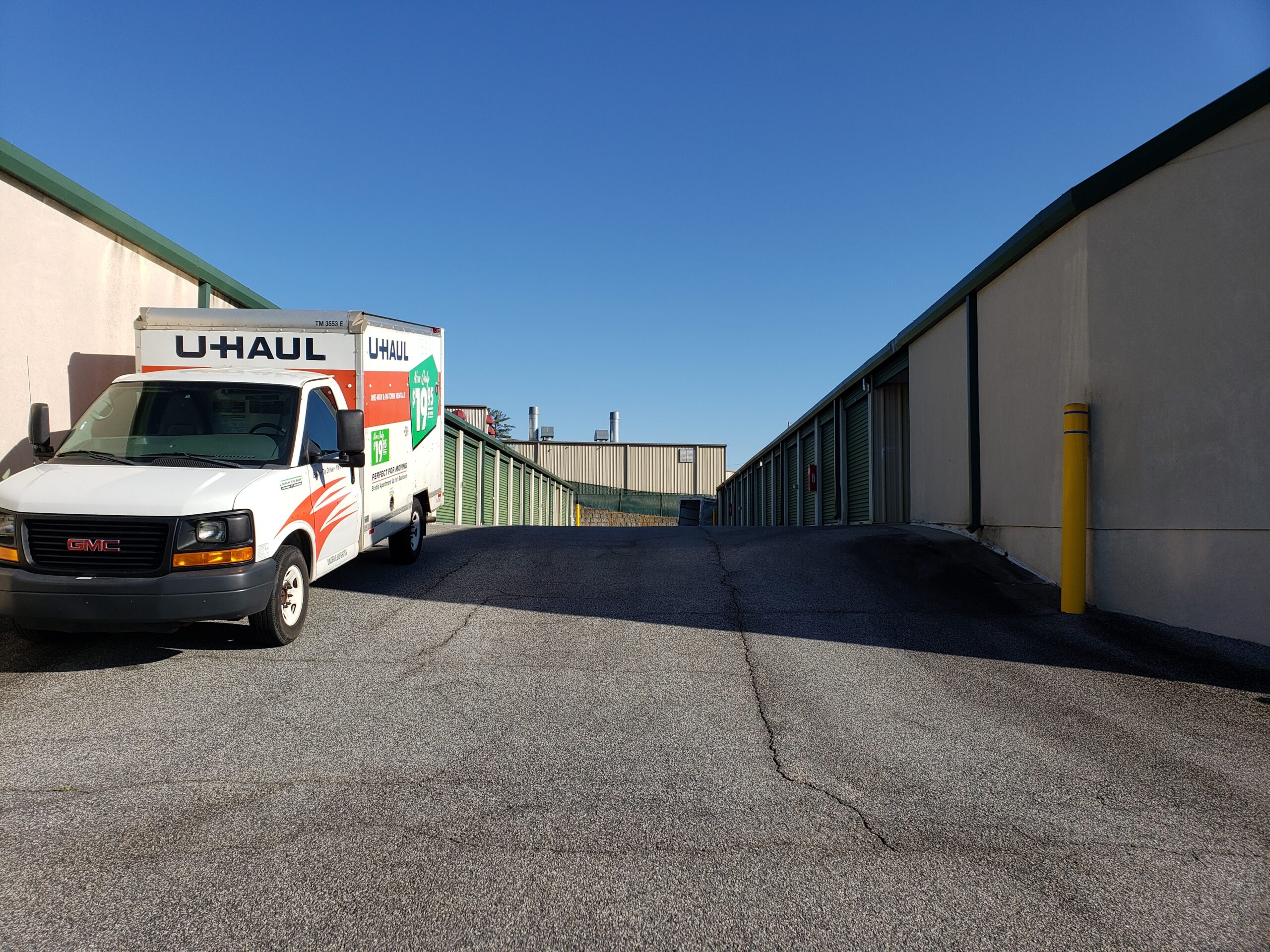 Two U-Haul trucks parked next to each other.
