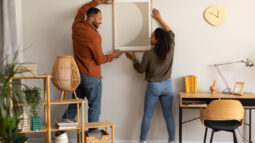 A man and woman decorating their spare room at home.
