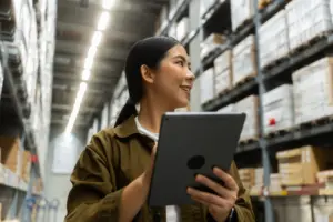 A businesswoman smiles while managing inventory and commercial storage solutions.
