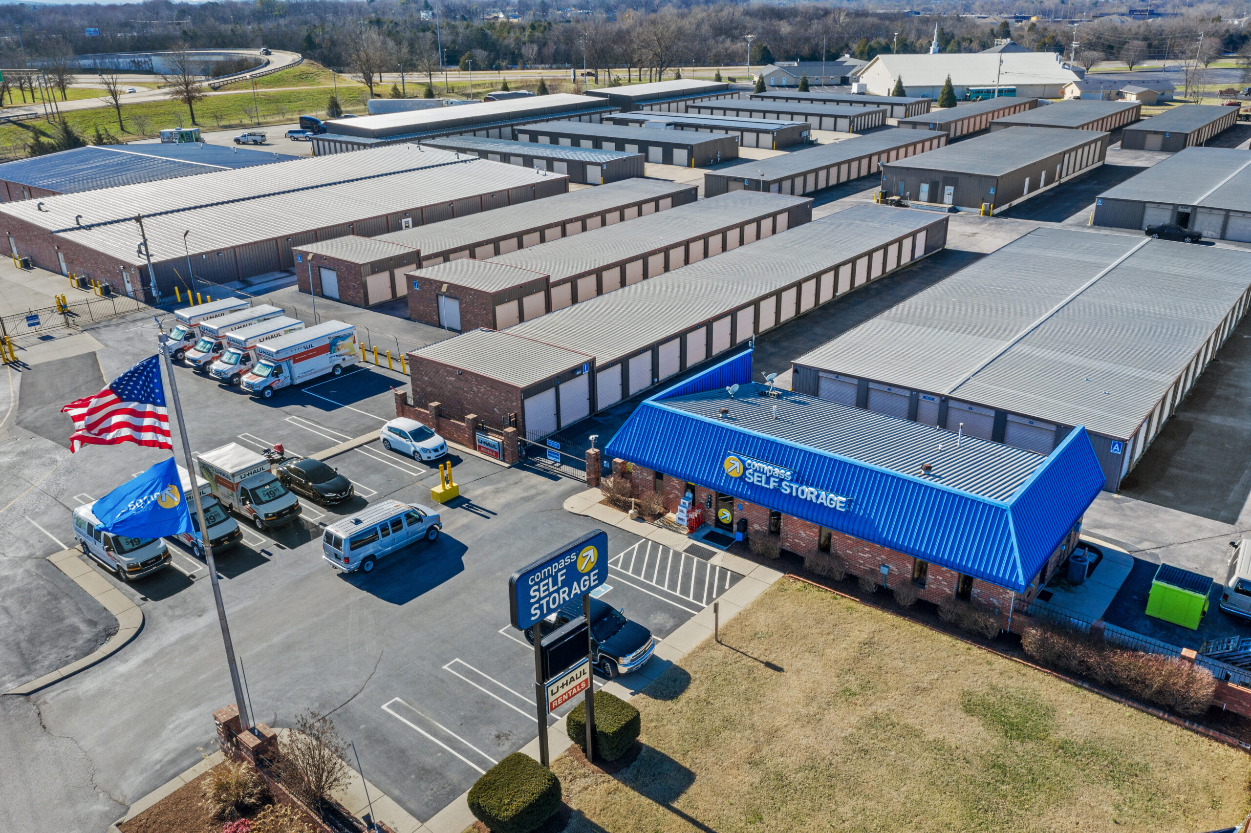 Aerial view of Compass Self Storage facility in Smyrna with storage units, main office, and U-Haul trucks.