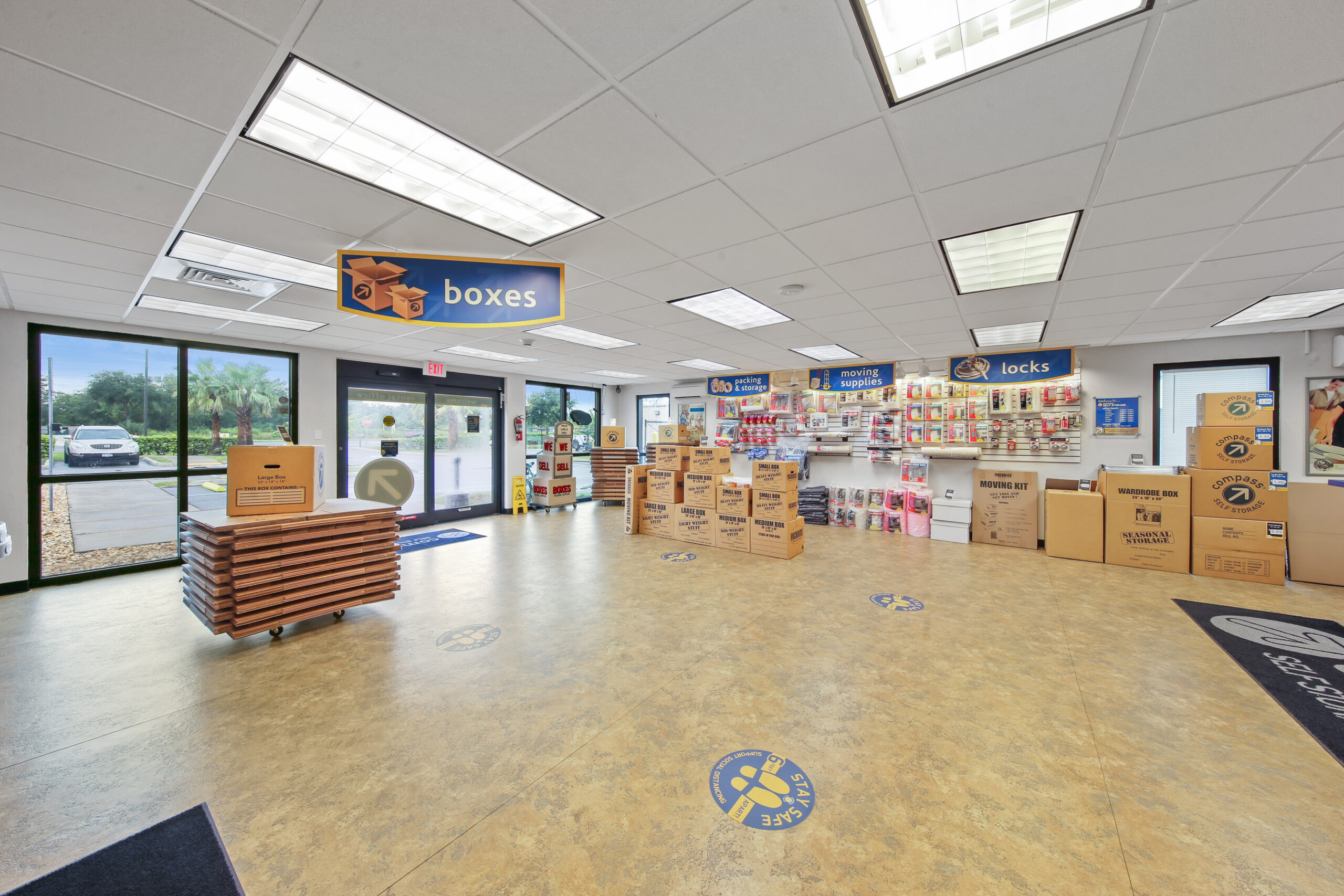 Compass Self Storage retail office with moving boxes, packing supplies, and locks for sale.